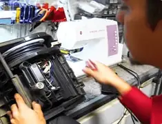 Vacuum repair technician servicing internal components on a workbench in Sioux Falls, SD